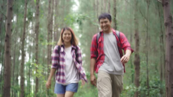 Hiker Asia backpacker couple on hiking adventure feeling freedom walk in forest their holidays.