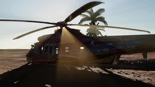 Old Rusted Military Helicopter in the Desert at Sunset alt
