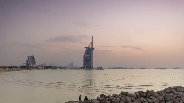 Dubai Skyline with Burj Al Arab Hotel During and Day to Night Timelapse