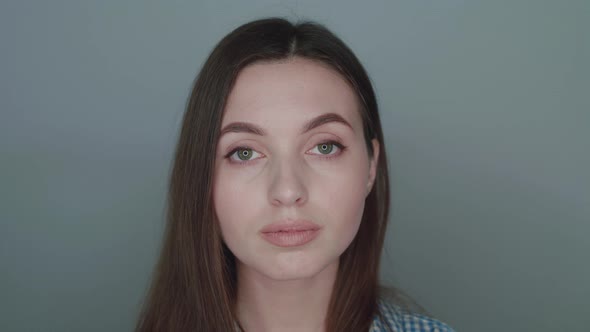 Portrait of the Girl Looking Right on Camera on Background