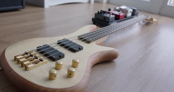Close Up Dolly of a Bass Guitar and Effect Pedals