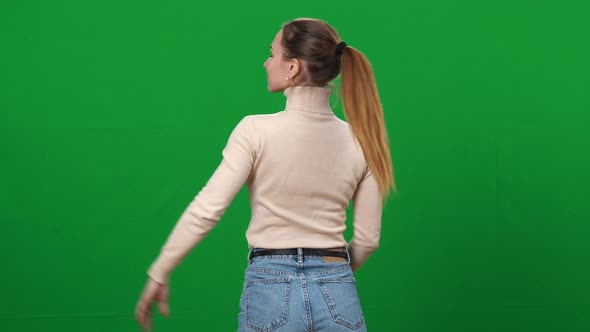 Slim Proud Woman Turning to Camera and Smiling Putting Hand on Hip