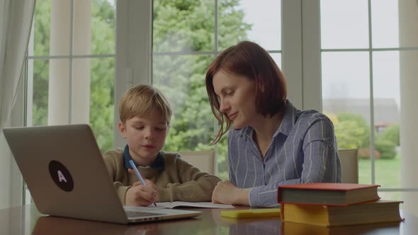 Mother Helping Her Son with Online Homework