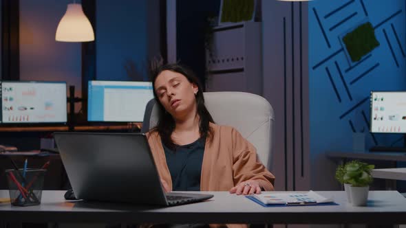 Exhausted Entrepreneur Woman Sleeping in Front of Laptop While Analysing Financial Statistics