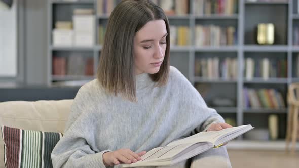 Portrait of Young Woman Reading Book