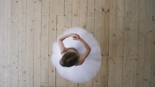 Top View Of Little Ballerina Whirling While Dancing