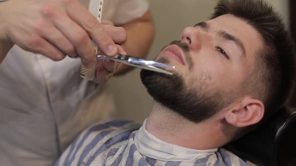 Client with Black Beard During Beard Shaving in Barber Shop. Groom, Masculine