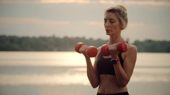 Woman Exercising With Dumbbells. Cardio Fitness Training. Outdoor Pumping Muscles Practicing.