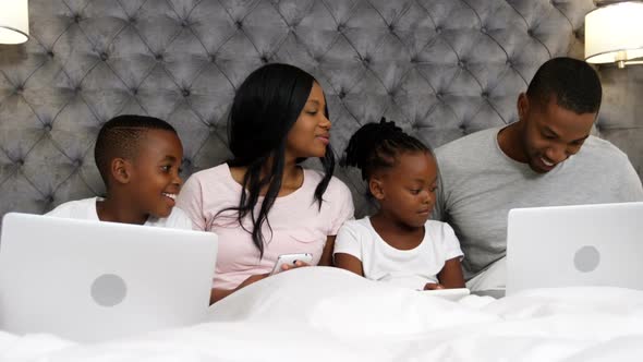 Family using electronic devices in bedroom 4k