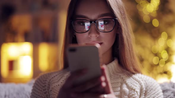 Charming Woman in Glasses Using Smartphone