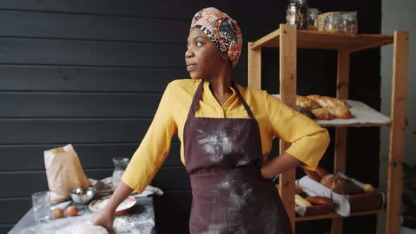 Portrait of Cheerful Afro-American Female Baker in Kitchen