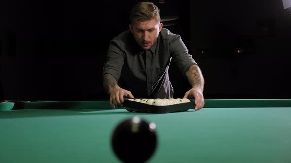 Triangle of Billiard Balls. A Man Getting Ready To Start a Game of Billiards.