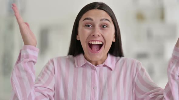 Portrait of Excited Young Latin Woman Celebrating Success