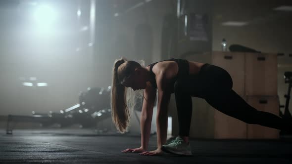 Young Slender Woman is Doing Physical Exercise on Floor in Gym Yoga and Fitness Training