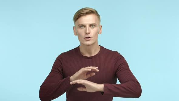 Handsome Caucasian Man with Blond Short Hair Shaking Head and Making Cross Gesture Saying No Forbid