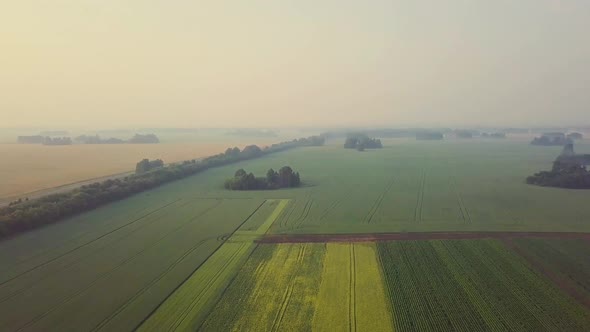 Aerial: Flying Over Beautiful Fields. Also Visible: Fog, Agroculture, Shadows From the Clouds