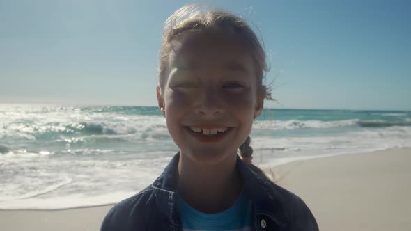 Young girl looking at the camera at the beach