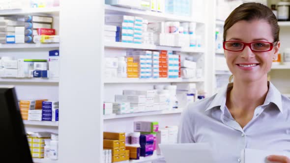 Pharmacist holding medicine and prescription