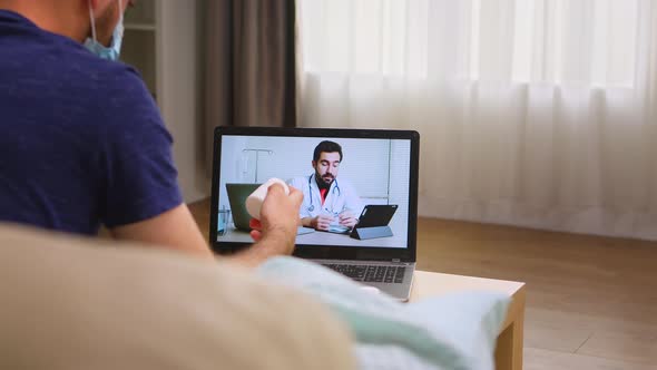Man Having an Online Consultation with His Doctor
