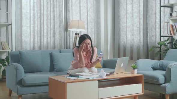 Woman With A Laptop Holding Credit Card And Smartphone Shaking His Head Due To Unable Pay Money