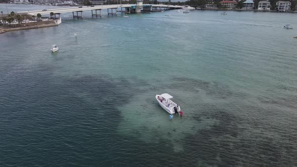 aerial of the boaters wading in the shallows of New Pass in Sarasota, Florida