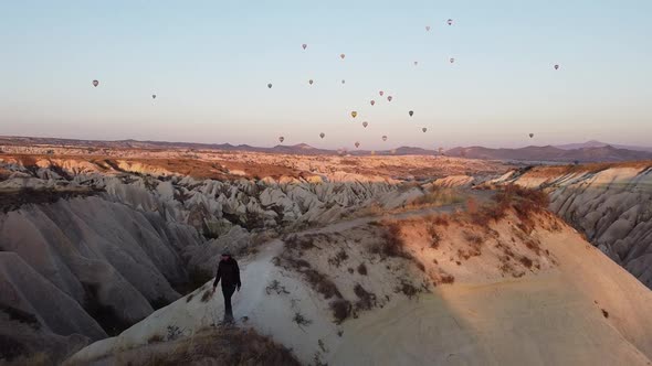 Walking in a paradise. Colorful hot air balloons flying over the famous valleys in Cappadocia, Turke