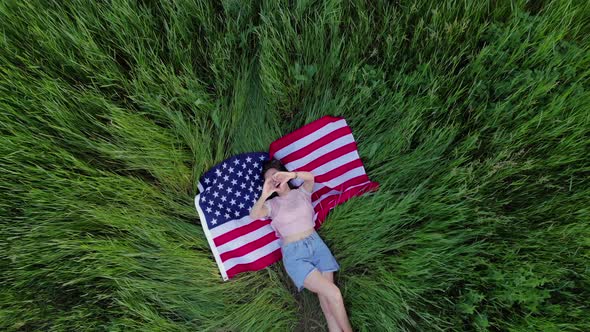 Happy Girl Lies on the USA Flag