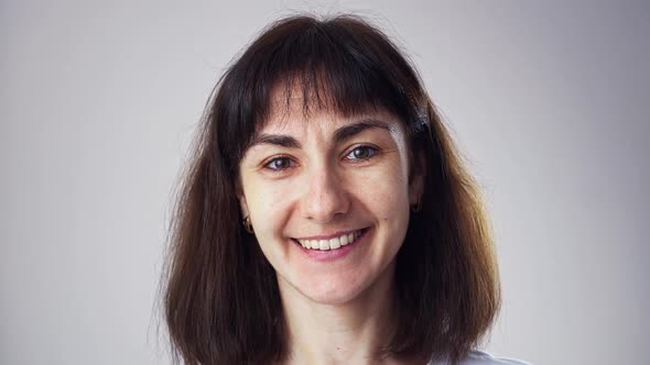 Close Up Head Shot Portrait 30s Beautiful Brunette Woman Smile Look at Camera