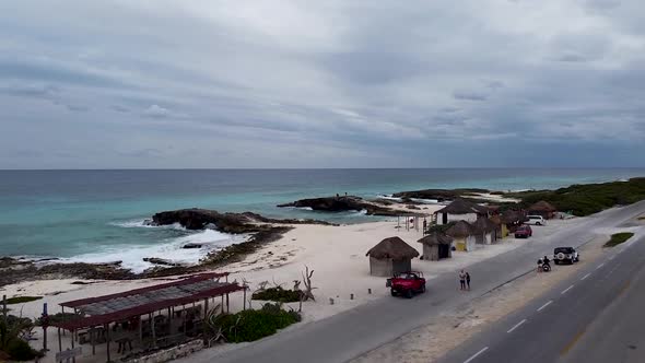 Aerial drone flying over a coastal road towards the El Mirador viewpoint and the Caribbean Sea in Co