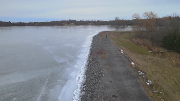 aerial drone following a young woman on a winter day