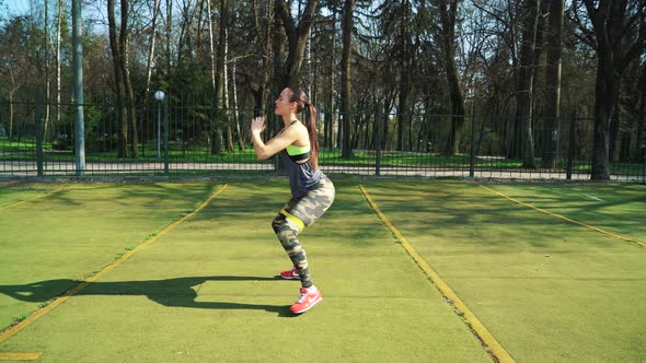 Woman doing exercises outdoors at the stadium