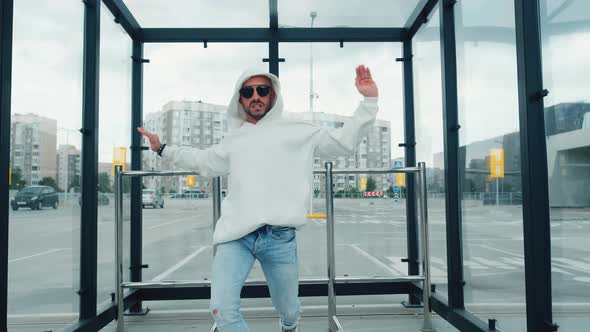 Fashionable Dancer Man in Sportswear and with Glasses Is Performing Outdoor Street Dancing Motion