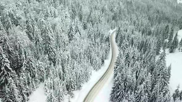 Aerial drone view of road in idyllic winter landscape.
