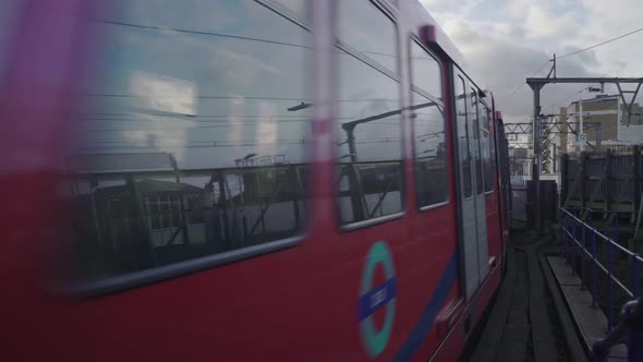 London DLR train is passing by  in a cloudy day