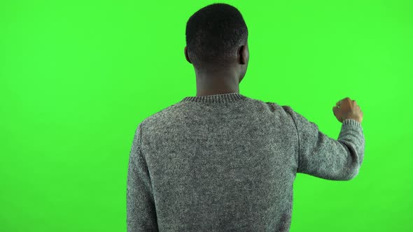 A Black Man Works on an Interactive Board - Green Screen Studio