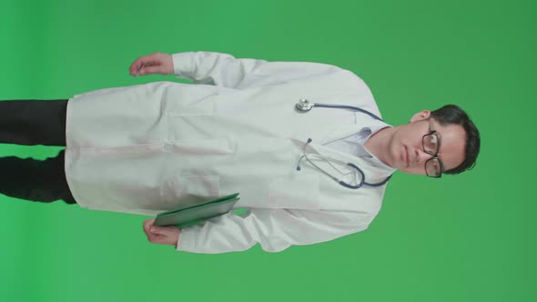 The Front View Of Asian Doctor With Stethoscope Holding Document File While Walking On Green Screen