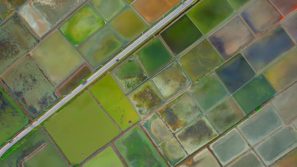 An aerial view from a drone flying over a salt fields, salt production.