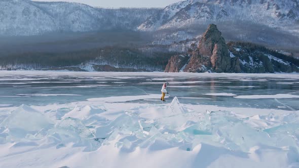 Aerial View of Man Skating on Lake Baikal Covered By Ice