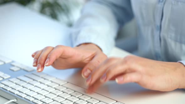 Female Hands Busy Working on Computer Keyboard for Sending Emails and Surf on a Web Browser