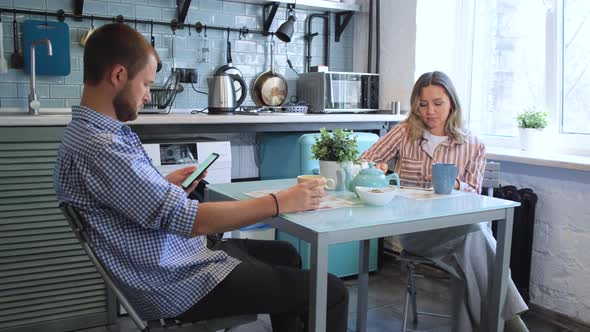 Young Couple Have Breakfast in Modern Kitchen. Tea Cup. Breakfast at Morning