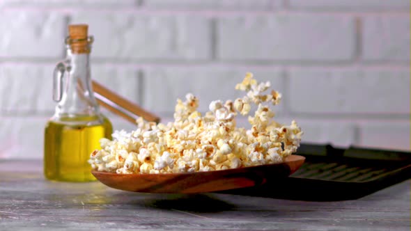 A Super Slow Motion Plate with Popcorn Falls on the Table