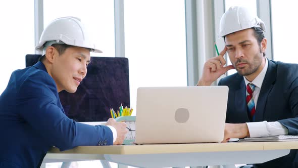 Engineer and Architect Meeting at Office Table