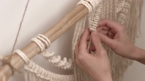 Woman Weaves Macrame on a Stick