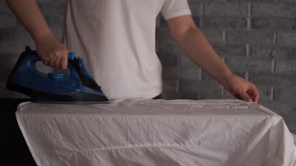 Woman Ironing Clothes on Ironing Board Closeup