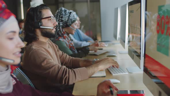 Middle Eastern Man in Headset Working in Call Center