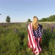 Unrecognizable Woman Wearing American Flag Stands In The Meadow And Mourns Her Soldier Husband - VideoHive Item for Sale