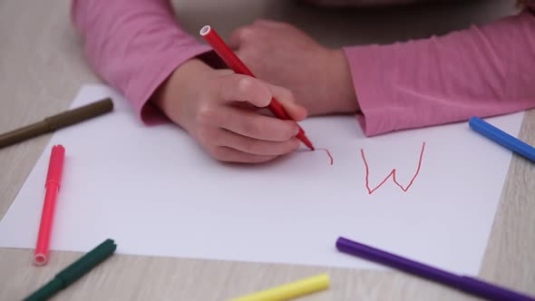 Pretty Child Girl Drawing a Postcard to Her Mother for Happy Mothers Day with Word Mom