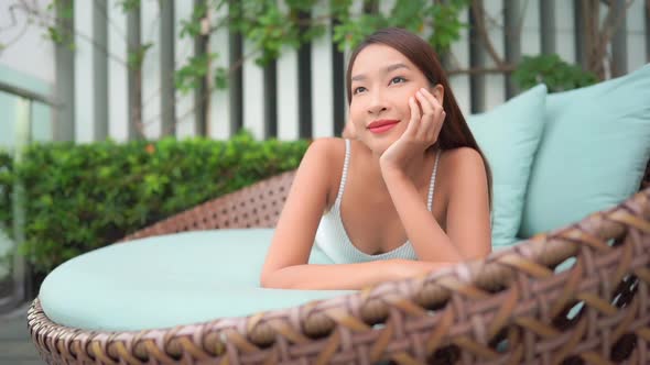 Young asian woman enjoy around outdoor swimming pool for leisure