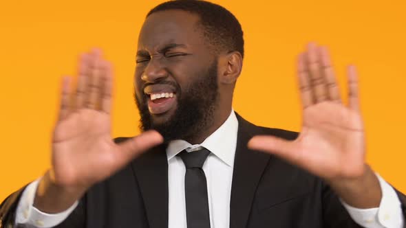 African-American Man in Suit Rejecting Poor-Quality Banking Services, Dislike