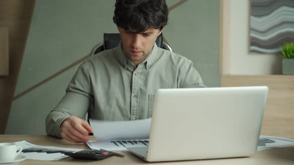 Frustrated Man While Sitting at His Working Place in Office